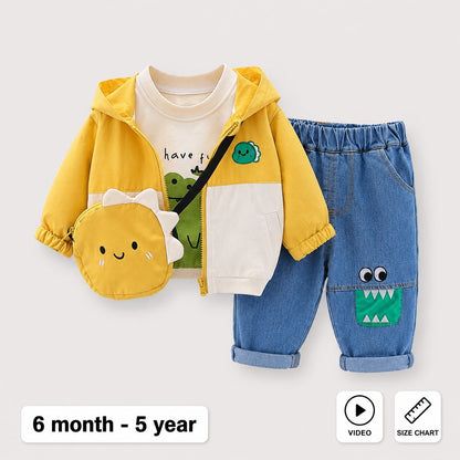A children's outfit set shown on a light gray background, including a yellow and white zip-up hoodie, blue jeans with a green monster patch, and a matching yellow dinosaur face pouch. Text at the bottom reads '6 month - 5 year' with video and size chart icons.